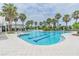 Large community pool surrounded by palm trees, offering a refreshing escape for residents to relax and enjoy at 32242 Summerglade Dr, Wesley Chapel, FL 33545