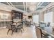Luxurious dining room featuring tiled floors, coffered ceilings, a sparkling chandelier, and built-in bar area at 32242 Summerglade Dr, Wesley Chapel, FL 33545