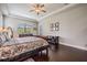 Primary bedroom showcasing hardwood floors, trey ceiling, and large dresser at 32242 Summerglade Dr, Wesley Chapel, FL 33545