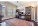 Bright office with natural light from large windows and a stylish rug at 32242 Summerglade Dr, Wesley Chapel, FL 33545