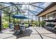 Inviting screened patio with outdoor dining and lounge area with views of the landscaped yard at 32242 Summerglade Dr, Wesley Chapel, FL 33545