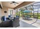 Screened patio with comfortable seating and dining area overlooking the backyard at 32242 Summerglade Dr, Wesley Chapel, FL 33545