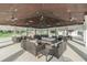 Outdoor pavilion with ample seating, ceiling fans, and elegant lighting, ideal for gatherings at 32242 Summerglade Dr, Wesley Chapel, FL 33545