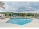 Inviting community pool with lounge chairs and a playground, perfect for relaxation and recreation at 32242 Summerglade Dr, Wesley Chapel, FL 33545