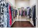 Walk-in closet featuring hardwood floors and organized clothing racks at 32242 Summerglade Dr, Wesley Chapel, FL 33545