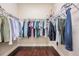 Walk-in closet featuring hardwood floors and organized clothing racks at 32242 Summerglade Dr, Wesley Chapel, FL 33545