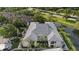 This aerial view highlights the well-maintained condo community with lush landscaping and a tranquil pond setting at 3366 Mermoor Dr # 1106, Palm Harbor, FL 34685