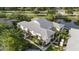 The building features a clean architectural style and inviting walkways, complemented by mature trees and manicured lawns at 3366 Mermoor Dr # 1106, Palm Harbor, FL 34685