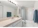 Clean bathroom featuring a wide mirror, full bathtub with shower, and light countertop at 3366 Mermoor Dr # 1106, Palm Harbor, FL 34685