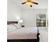 Bright bedroom features a ceiling fan, window with natural light, and neutral tile flooring at 3366 Mermoor Dr # 1106, Palm Harbor, FL 34685