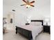 Cozy bedroom with ceiling fan, neutral decor, and an ensuite bathroom at 3366 Mermoor Dr # 1106, Palm Harbor, FL 34685