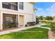Condo exterior with a cozy patio and lawn, conveniently located near the parking area at 3366 Mermoor Dr # 1106, Palm Harbor, FL 34685