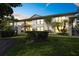 Well-maintained condo building showcasing manicured lawn and tropical landscaping at 3366 Mermoor Dr # 1106, Palm Harbor, FL 34685