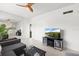 Bright living room with large flatscreen TV, tile flooring, a ceiling fan, and a plant at 3366 Mermoor Dr # 1106, Palm Harbor, FL 34685