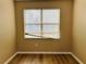 Neutral bedroom featuring a window and laminate wood flooring at 3531 High Hampton Cir, Tampa, FL 33610