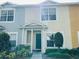 Charming townhome featuring a teal front door, well-maintained landscaping, and colorful facade at 3531 High Hampton Cir, Tampa, FL 33610