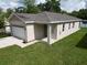 Charming single-story home featuring a one car garage and beautifully manicured lawn at 36755 Thomas Jefferson Rd, Dade City, FL 33525
