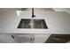 Close up shot of a kitchen island and stainless steel sink at 36755 Thomas Jefferson Rd, Dade City, FL 33525