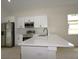 View of the kitchen with stainless steel appliances and white cabinets at 36755 Thomas Jefferson Rd, Dade City, FL 33525