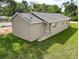 Backyard view of the house with stairs leading to the door at 36777 Thomas Jefferson Rd, Dade City, FL 33525