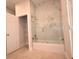 This bathroom features a tub with a glass door and a closet with shelving at 36777 Thomas Jefferson Rd, Dade City, FL 33525