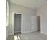 Bedroom with two doors and a closet with wire rack shelving at 36777 Thomas Jefferson Rd, Dade City, FL 33525