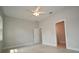 Bright bedroom with ceiling fan and view of bathroom through doorway at 36777 Thomas Jefferson Rd, Dade City, FL 33525