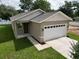 Lovely one-story home featuring a two-car garage, and manicured lawn at 36777 Thomas Jefferson Rd, Dade City, FL 33525