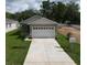 Charming one-story home featuring a two-car garage and a concrete driveway at 36777 Thomas Jefferson Rd, Dade City, FL 33525