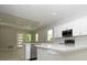 Open-concept kitchen with white cabinets, stainless steel appliances, and a view into the living area at 36777 Thomas Jefferson Rd, Dade City, FL 33525