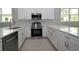 Bright kitchen with white cabinets, stainless steel appliances, quartz countertops, and modern fixtures at 36777 Thomas Jefferson Rd, Dade City, FL 33525