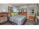 Eclectic bedroom with striped bedding, colorful accents, modern artwork, and a cozy, well-lit atmosphere at 37017 Sagemoor Dr, Zephyrhills, FL 33541