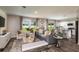 Spacious living area with a modern couch, chairs, and entertainment center, designed for comfort and stylish living at 37122 Sagemoor Dr, Zephyrhills, FL 33541