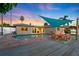 Relaxing backyard pool area with a spacious deck, mature landscaping and sunset in the background at 3912 Doral Dr, Tampa, FL 33634
