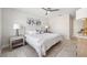 Bright bedroom with neutral colors, a large window, ceiling fan, and a well-appointed bed at 3912 Doral Dr, Tampa, FL 33634