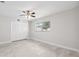 Minimalist bedroom with light walls, tile floors, a ceiling fan, and a closet at 3912 Doral Dr, Tampa, FL 33634