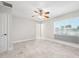 Spacious bedroom features tile flooring, a ceiling fan, and a large window with views of the canal at 3912 Doral Dr, Tampa, FL 33634
