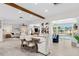 Open-concept dining area leading to living room and poolside space with great natural light at 3912 Doral Dr, Tampa, FL 33634