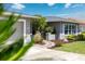 Exterior elevation with well-maintained lawn, landscaping, and paver walkway at 3912 Doral Dr, Tampa, FL 33634