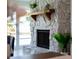 Living room fireplace with stone surround and wooden mantel, next to sliding glass doors and canal view at 3912 Doral Dr, Tampa, FL 33634