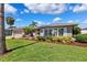 Charming single-story home with lush landscaping and a well-maintained lawn at 3912 Doral Dr, Tampa, FL 33634
