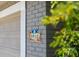 Charming home exterior featuring a creatively tiled address marker on a gray brick wall near a garage door at 3912 Doral Dr, Tampa, FL 33634