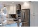 Close-up of updated kitchen featuring stainless steel appliances, granite counters, and modern finishes at 3912 Doral Dr, Tampa, FL 33634