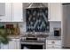 Close up view of the kitchen featuring modern appliances and stylish backsplash at 3912 Doral Dr, Tampa, FL 33634