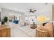 Spacious living room with an open floor plan, tile flooring, ceiling fan, and access to additional living spaces at 3912 Doral Dr, Tampa, FL 33634