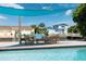 Inviting poolside outdoor lounge area with comfortable seating and waterfront views under a sunshade at 3912 Doral Dr, Tampa, FL 33634