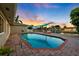 Beautiful pool area with an outdoor lounge and waterfront views at sunset at 3912 Doral Dr, Tampa, FL 33634