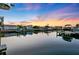 Stunning waterfront view at sunset showcasing docks and boats on tranquil, reflective waters at 3912 Doral Dr, Tampa, FL 33634