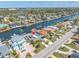 Stunning aerial view of waterfront home featuring a private pool and canal access, with lush landscaping at 4055 Floramar Ter, New Port Richey, FL 34652