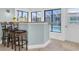 A bar area near the pool features granite countertops, seating, and a view of the outdoor pool area at 4055 Floramar Ter, New Port Richey, FL 34652